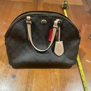 Coach handbag with cross body strap.